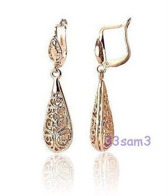 gold dangling earrings in Earrings