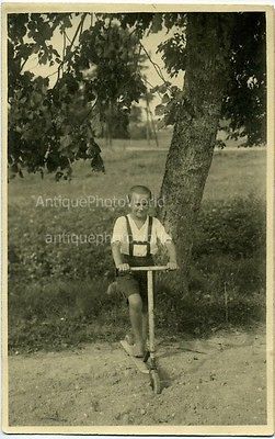 Boy on scooter antique toy photo